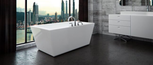 A large white bathtub in front of a window.