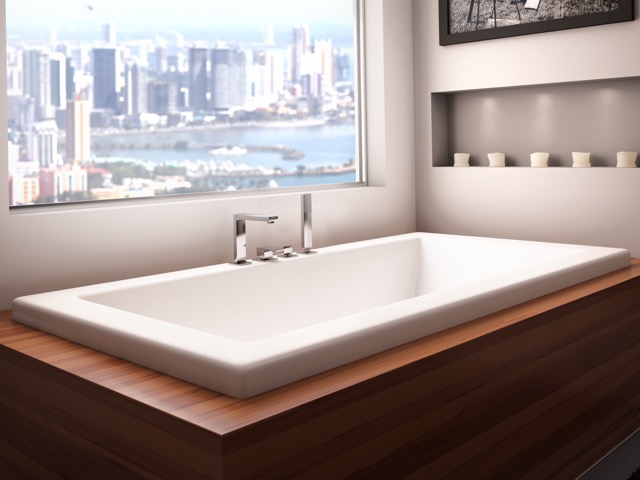 A bathtub with a view of the city.